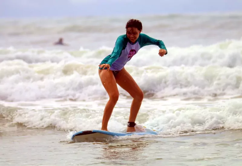 Teenager surfing in Playa El Carmen, Santa Teresa, Costa Rica,.