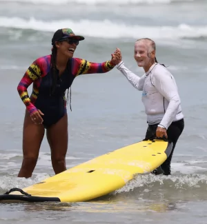 surf instructor greeting student