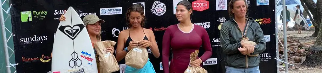 women receiving prices after surf tournament