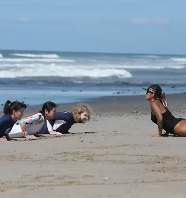 woman surf coach giving lessons on beach