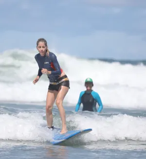 surf instructor watches student from afar