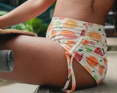 woman dressing white shorts with fruit patterns