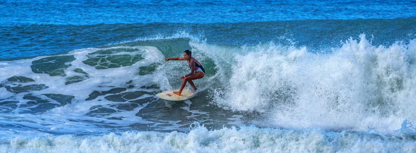 woman surfing in costa rica